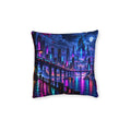 Cushion artwork: A futuristic skyline glows in cyan, violet and hot pink above dark water, with elevated walkways and tall towers reflected below.