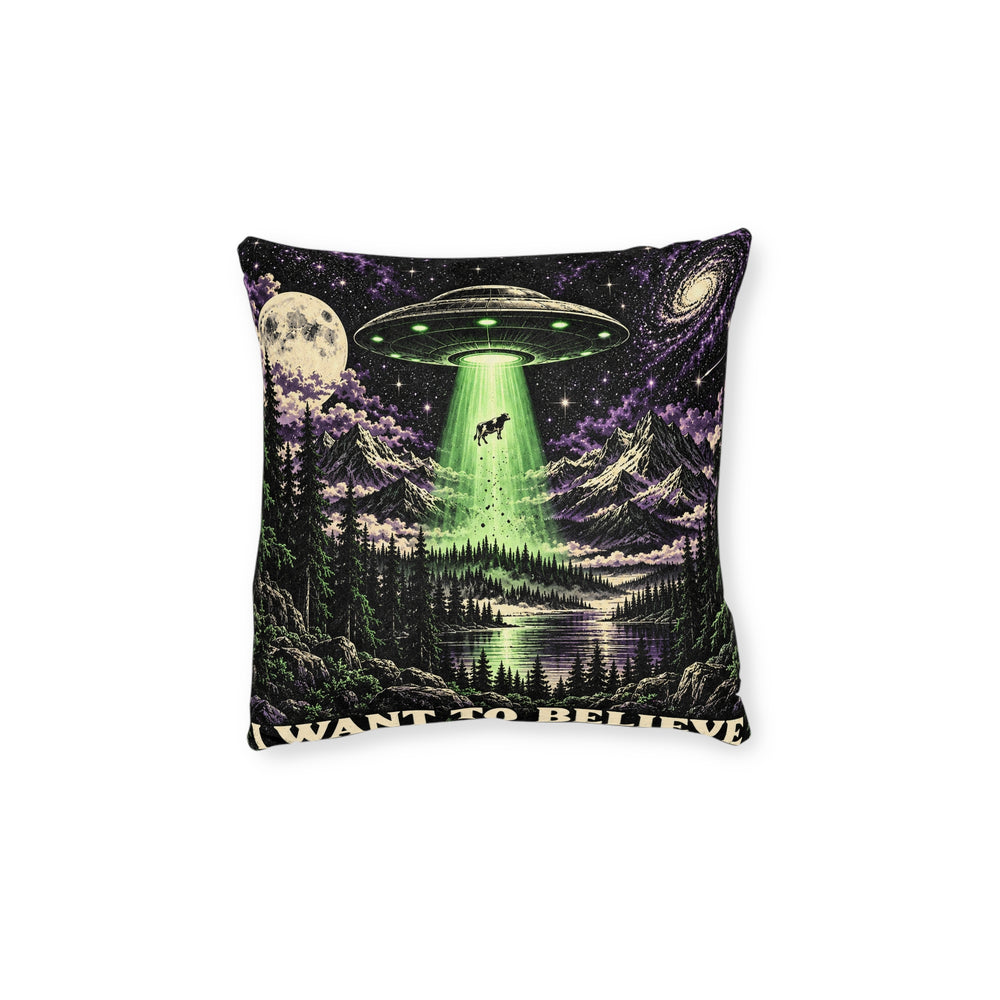 Cushion artwork: A flying saucer hovers above a moonlit forest, sending a vivid green beam down towards the trees and lifting a tiny cow into the sky.