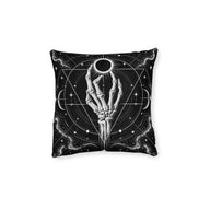 Cushion artwork: A skeletal hand reaches towards a dark eclipsed sun, its fingers curving around the bright rim of light.