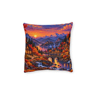 Cushion artwork: An autumn village glows beside a winding river beneath a vivid orange sunset, with a stone bridge, small waterfalls and distant mountains adding depth.