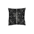 Cushion artwork: An ornate dagger with a skull pommel stands between curling rose stems, its long blade surrounded by crescent moons and fine geometric circles.