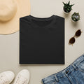 Folded plain black t-shirt, styled flat lay.