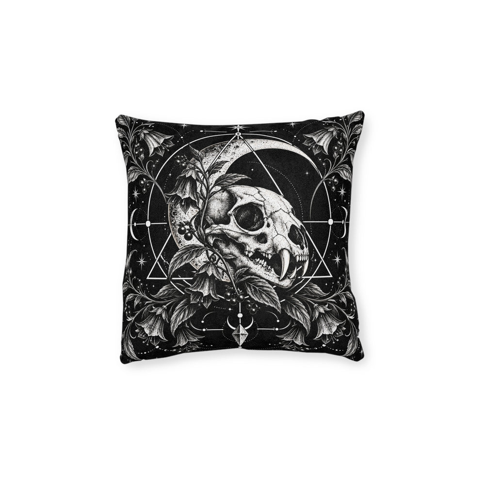 Cushion artwork: A feline skull nestles among curling leaves and berries beneath a broad crescent moon, with fine circles and triangular lines framing the composition.
