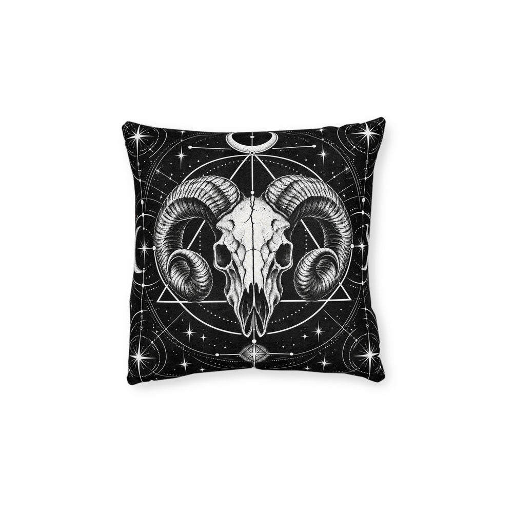 Cushion artwork: A ram skull faces forward with deeply curled horns, surrounded by intersecting circles, triangles and starbursts.